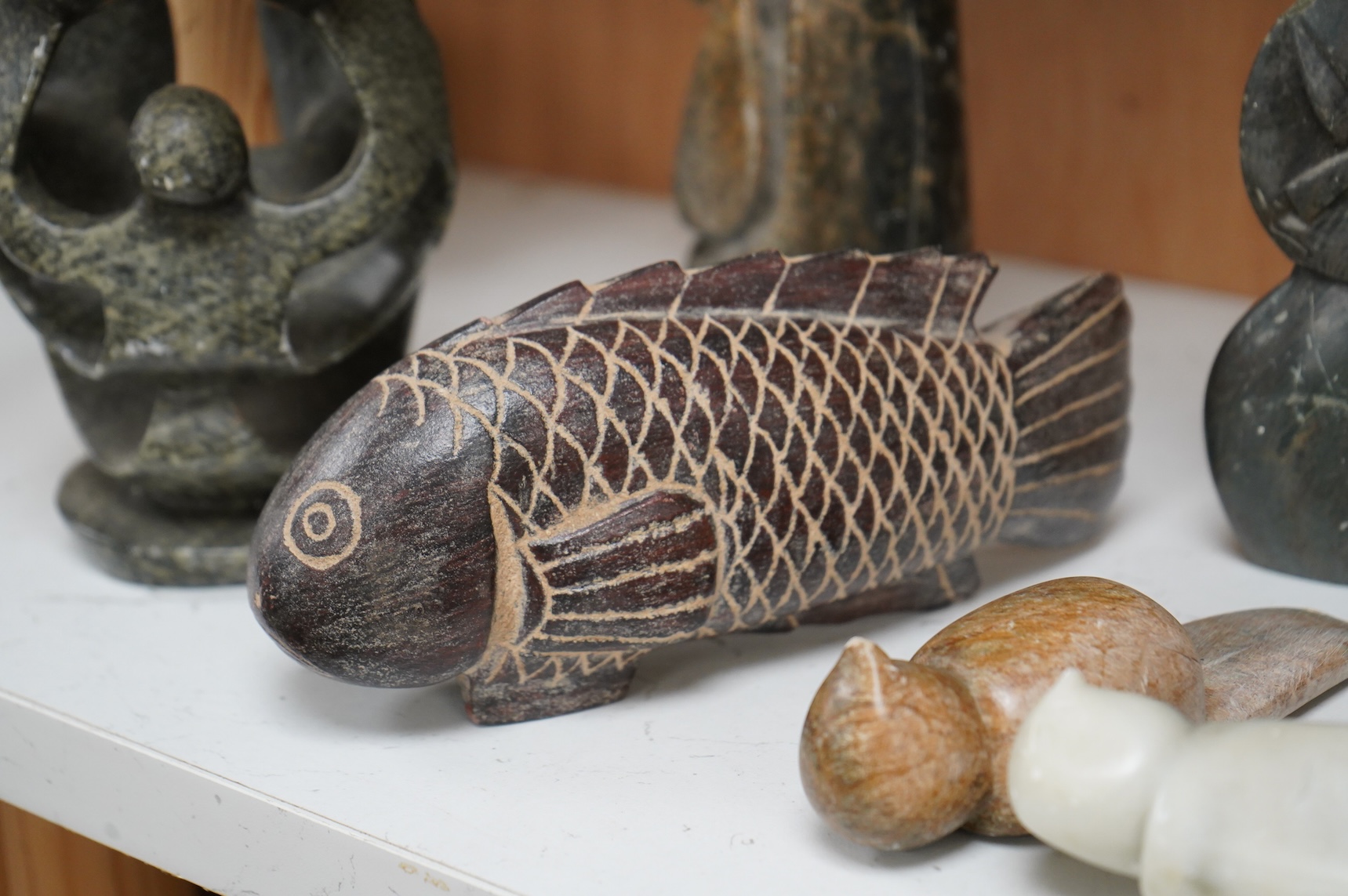Eleven Inuit related stone carvings, unsigned, to include birds and abstract figures, largest 22cm high